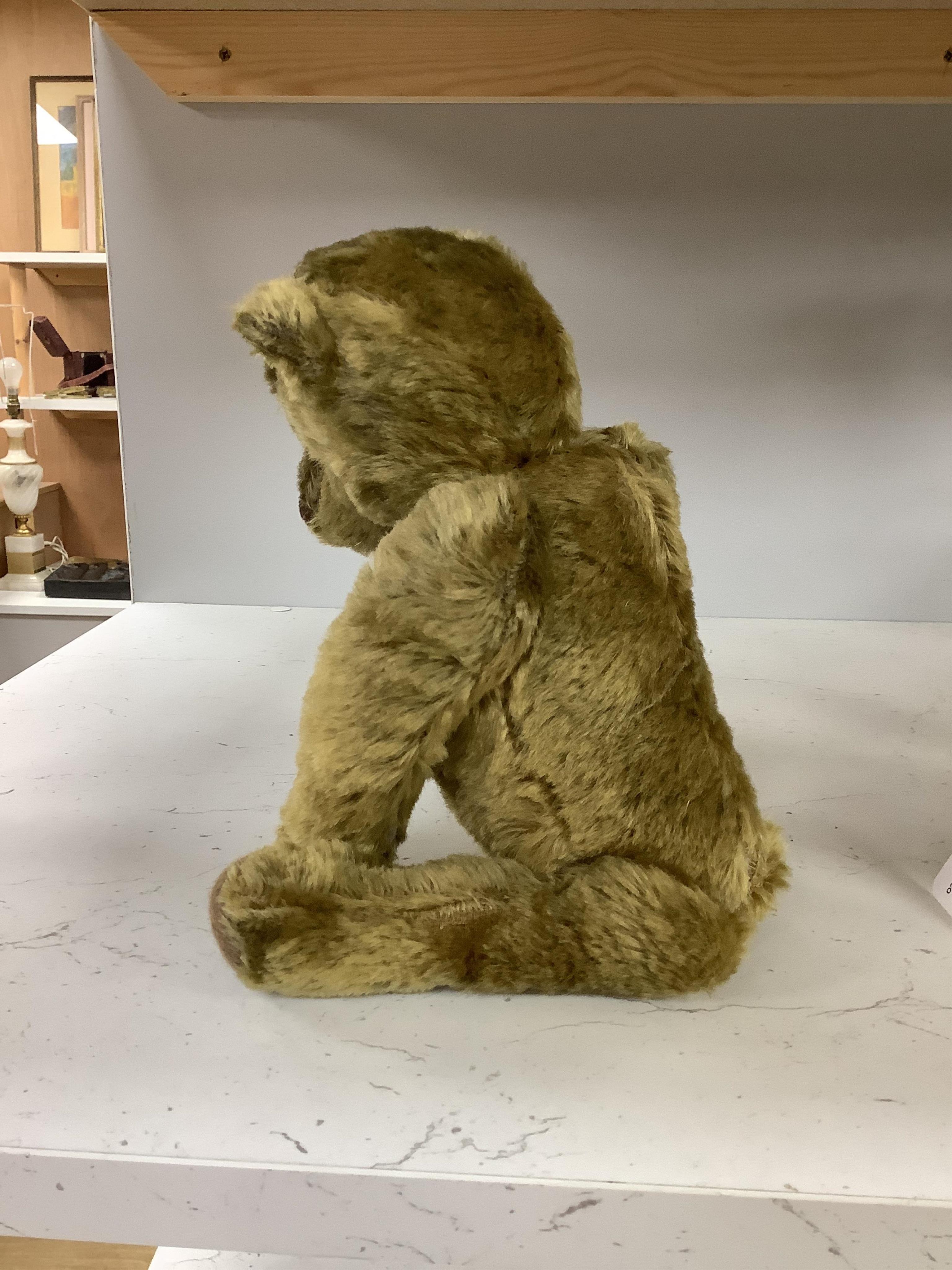 An early 20th century German hump backed plush teddy bear and three others, German teddy 30cm high. Condition - the German teddy has a short split on the back seam and glue on the front leg that needs removing and plush